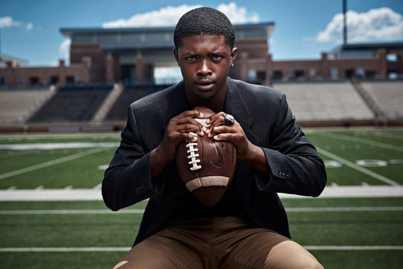Allen senior portraits eagles football captain mo perkins in stands crushing football