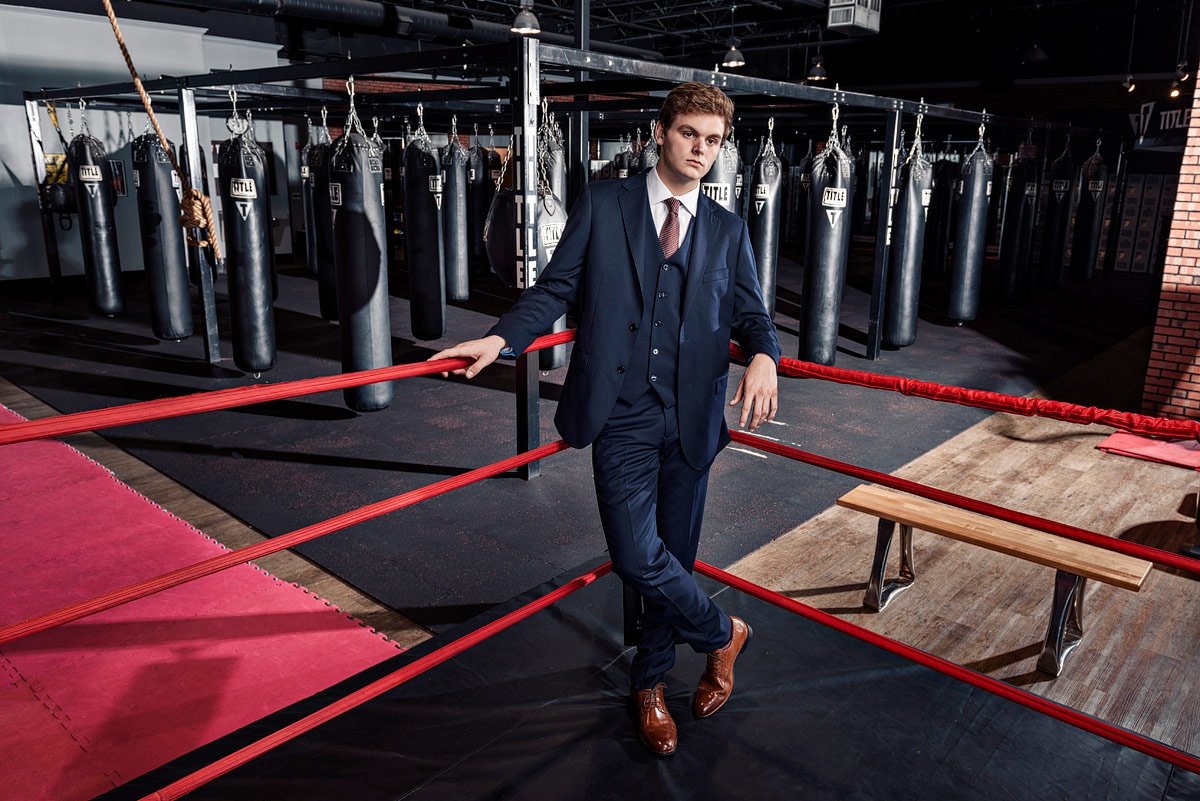 plano senior photos in boxing gym wearing blue suit from ISW plano tx