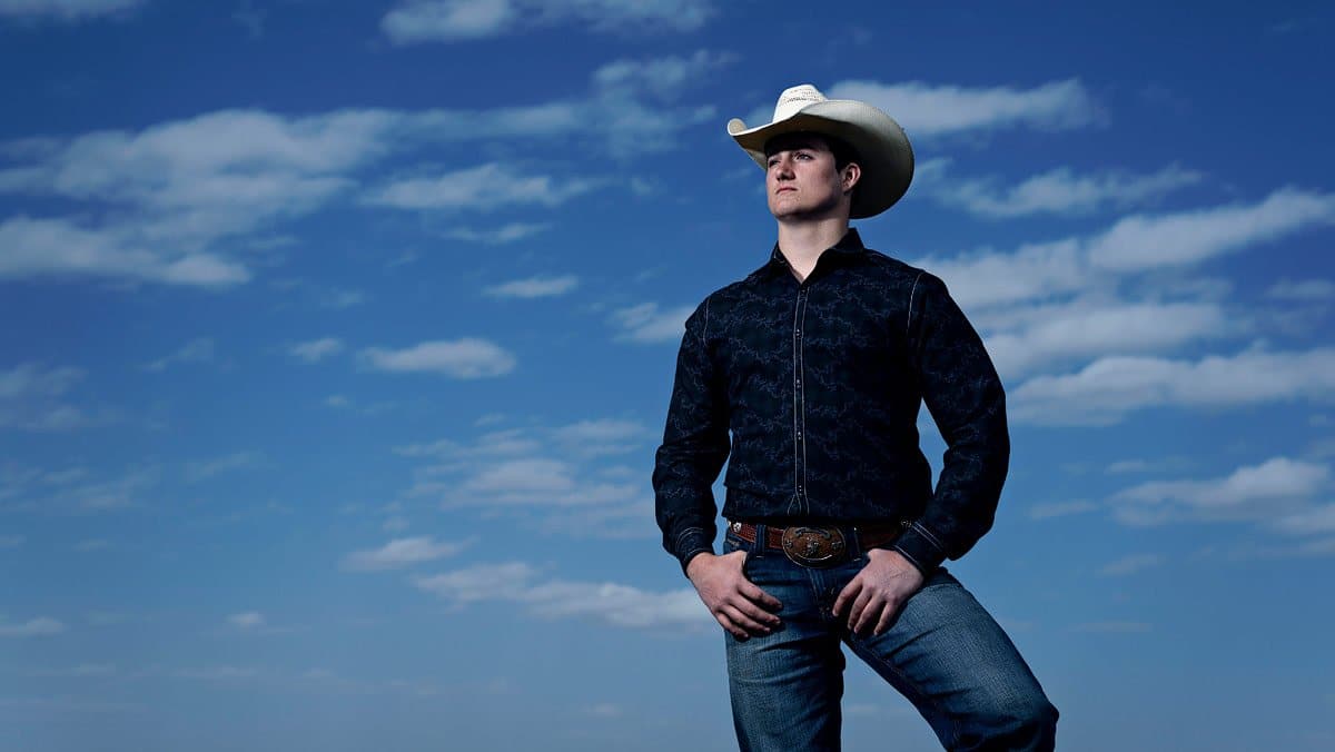 dallas boys senior pictures in cowboy hat with blue skies by mckinney photographer