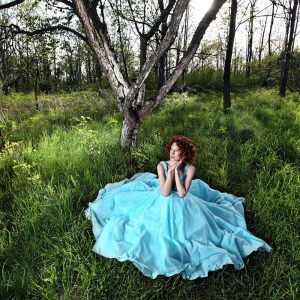 dallas senior girl wears teal prom gown in the woods for photos
