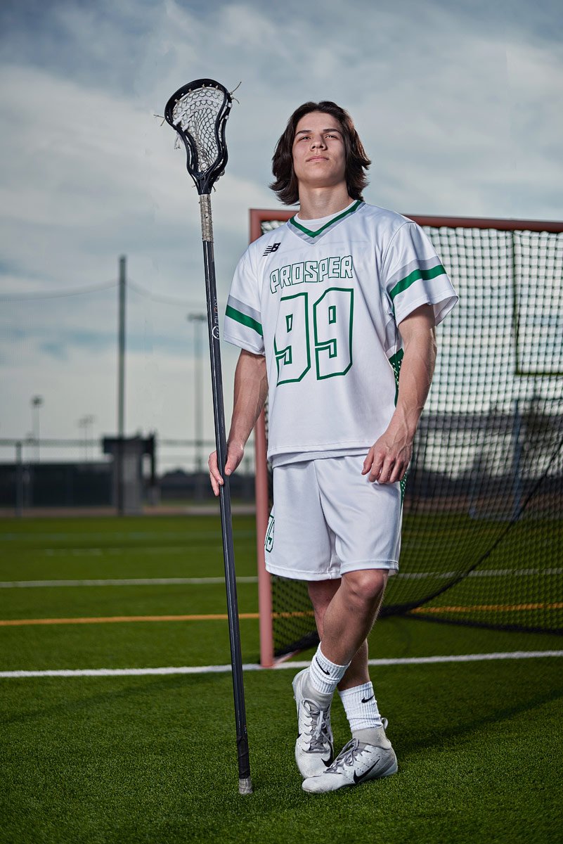 lacrosse player standing in front of the goal with stick for prosper high school
