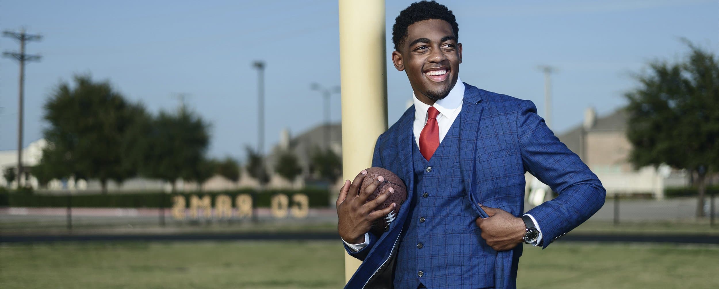 senior pictures in mckinney texas by jeff dietz photography of McKinney north football player in suit