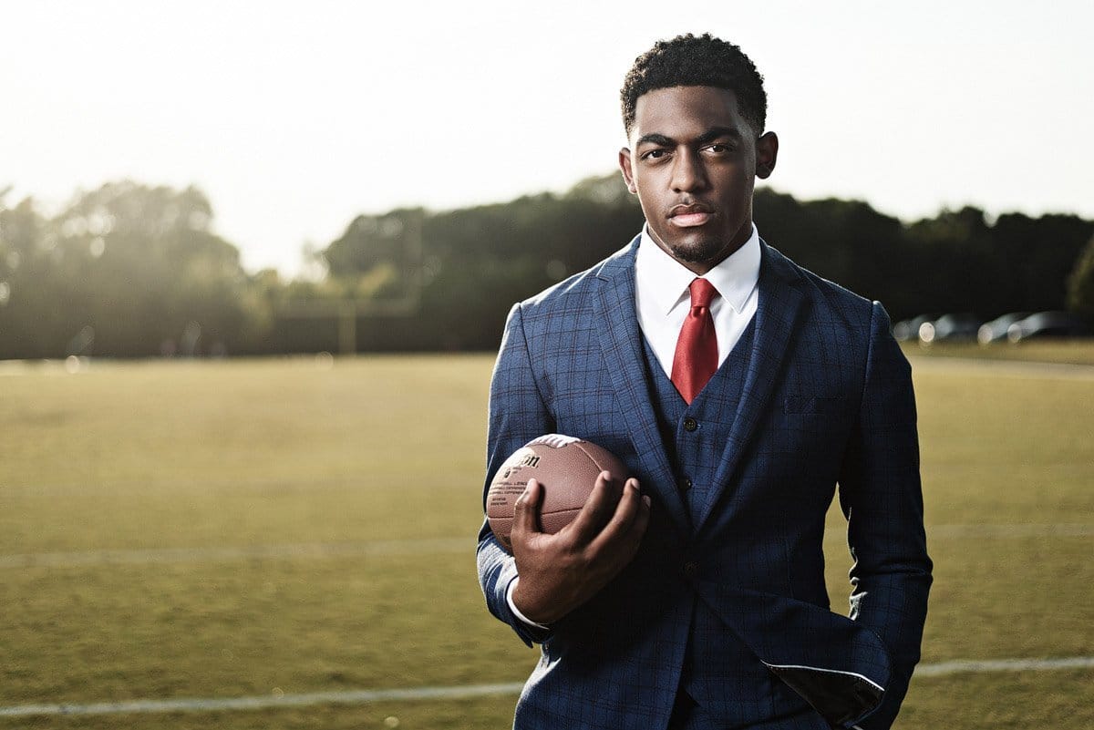 senior pictures in mckinney north high school football player in suit
