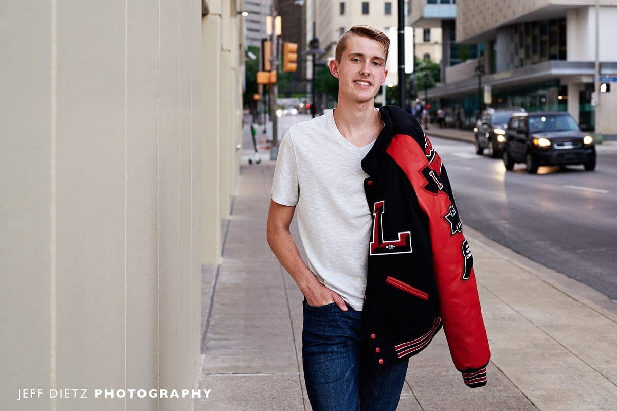 frisco liberty senior pictures in letterman jacket track and field walking